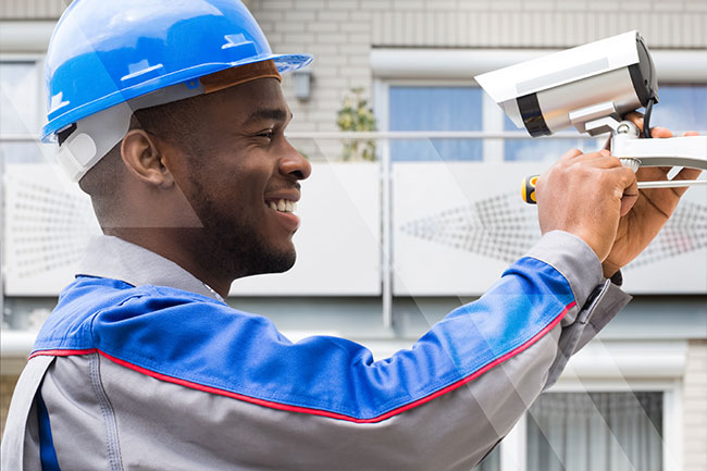 Technician installing security camera